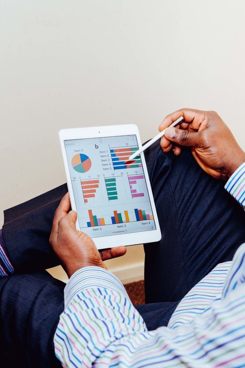 Businessman using a tablet for data analysis in a relaxed office setting.